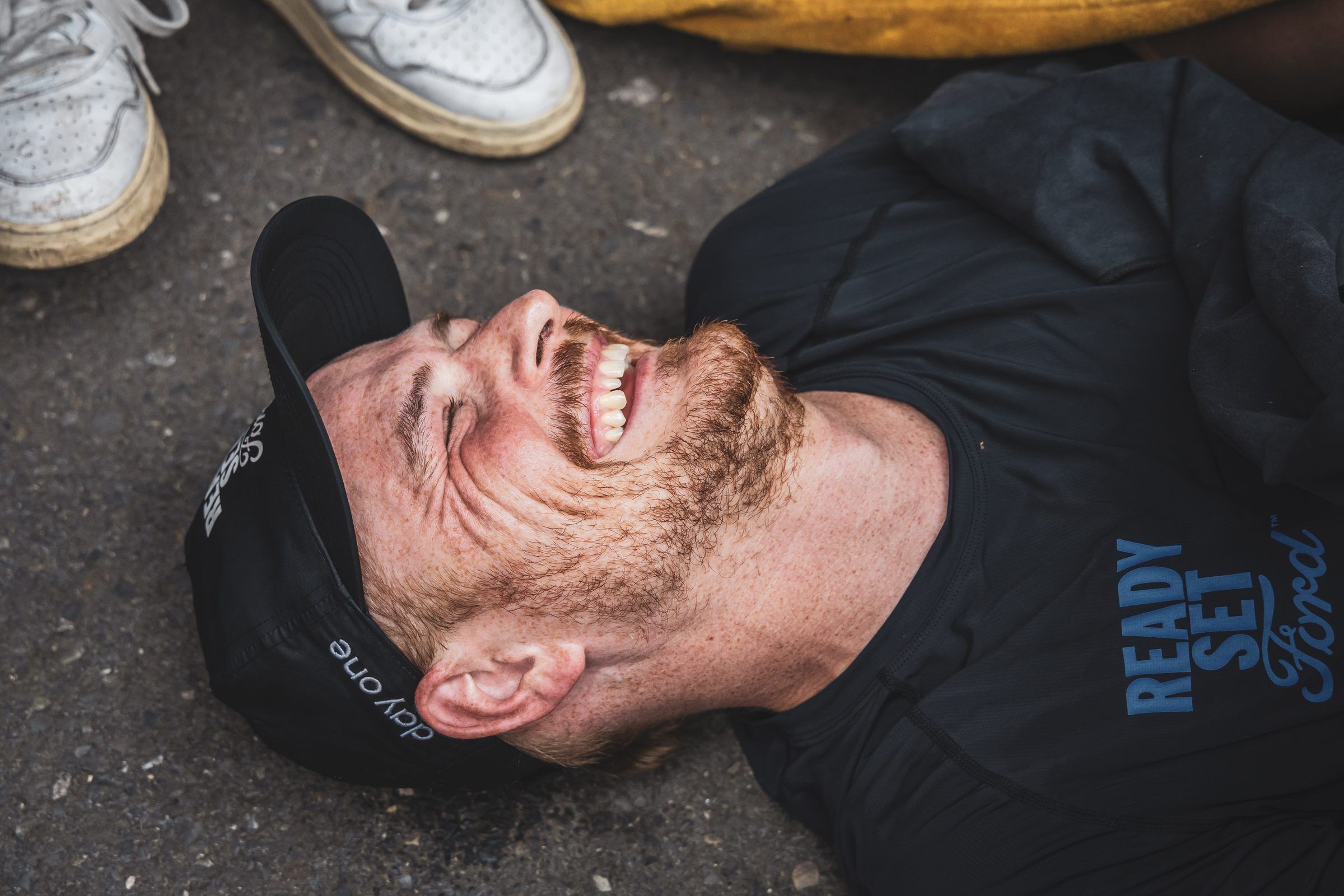 Pierre lying on the ground after his last lap, smiling