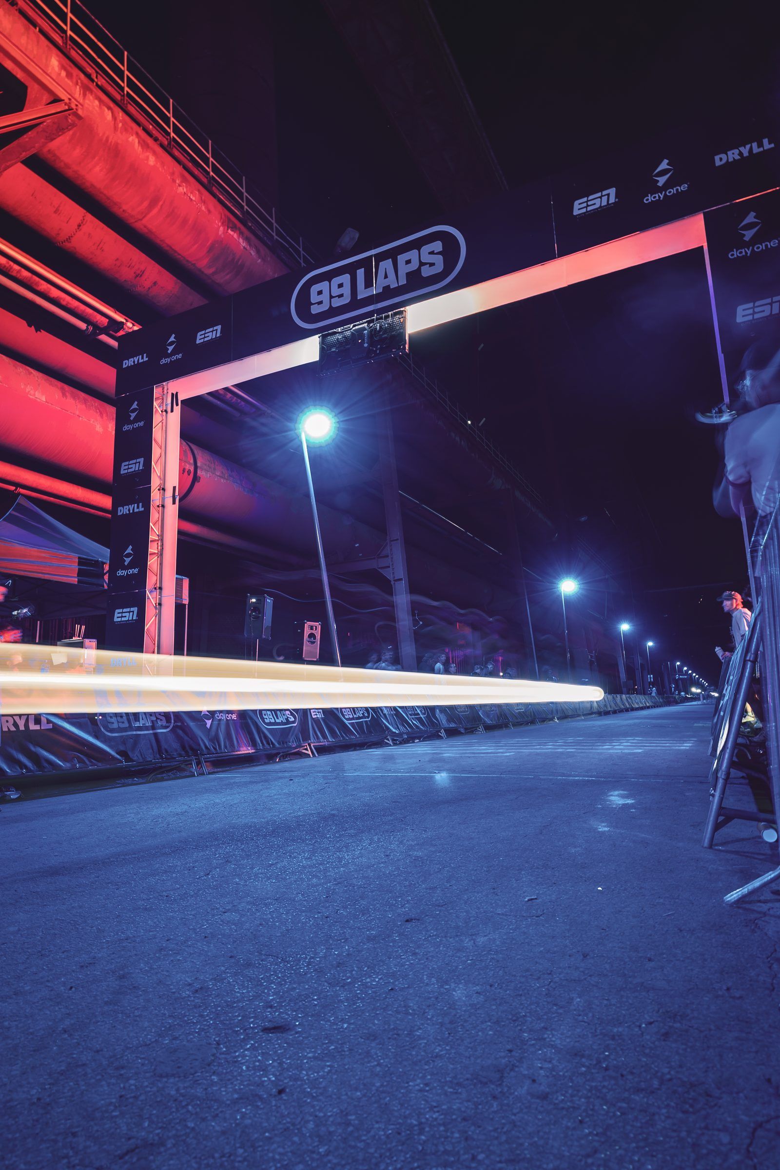Long exposure of the 99 Laps arch at night, a light trail across the course