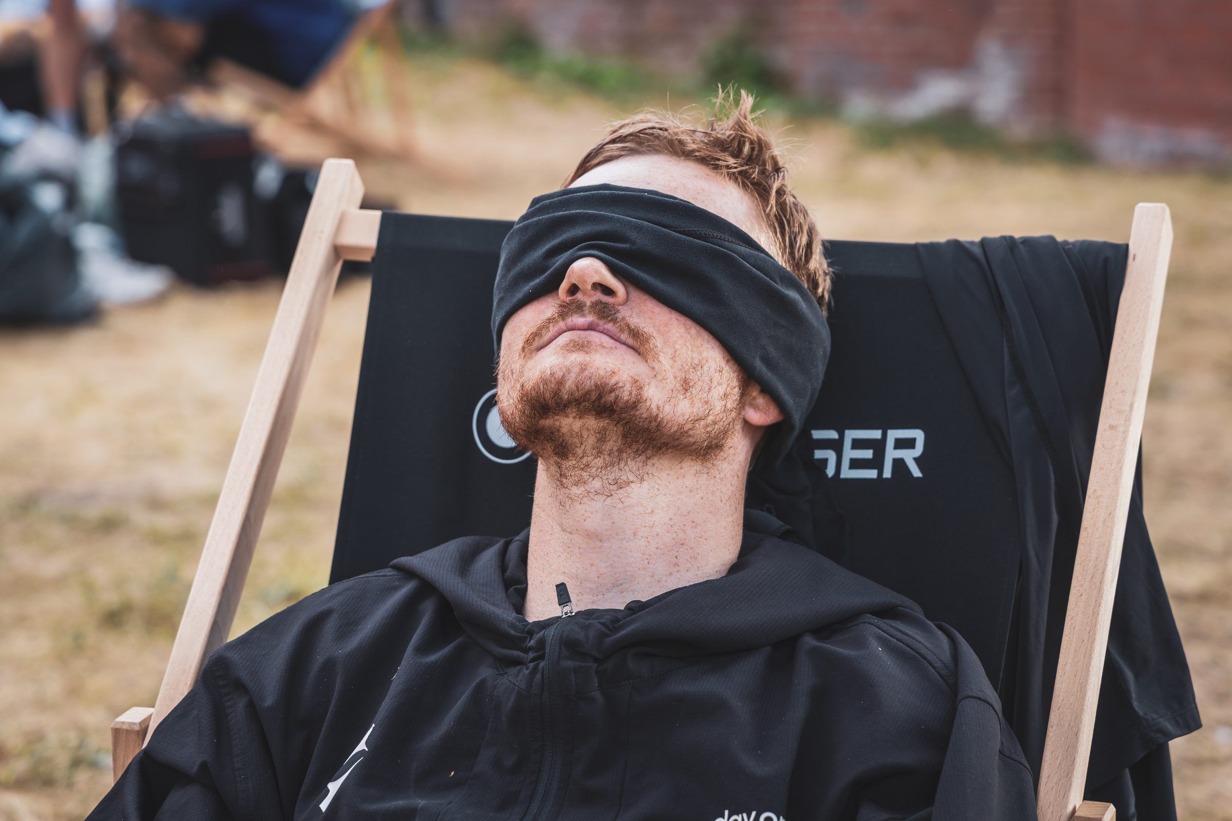 Pierre resting blindfolded in a deck chair