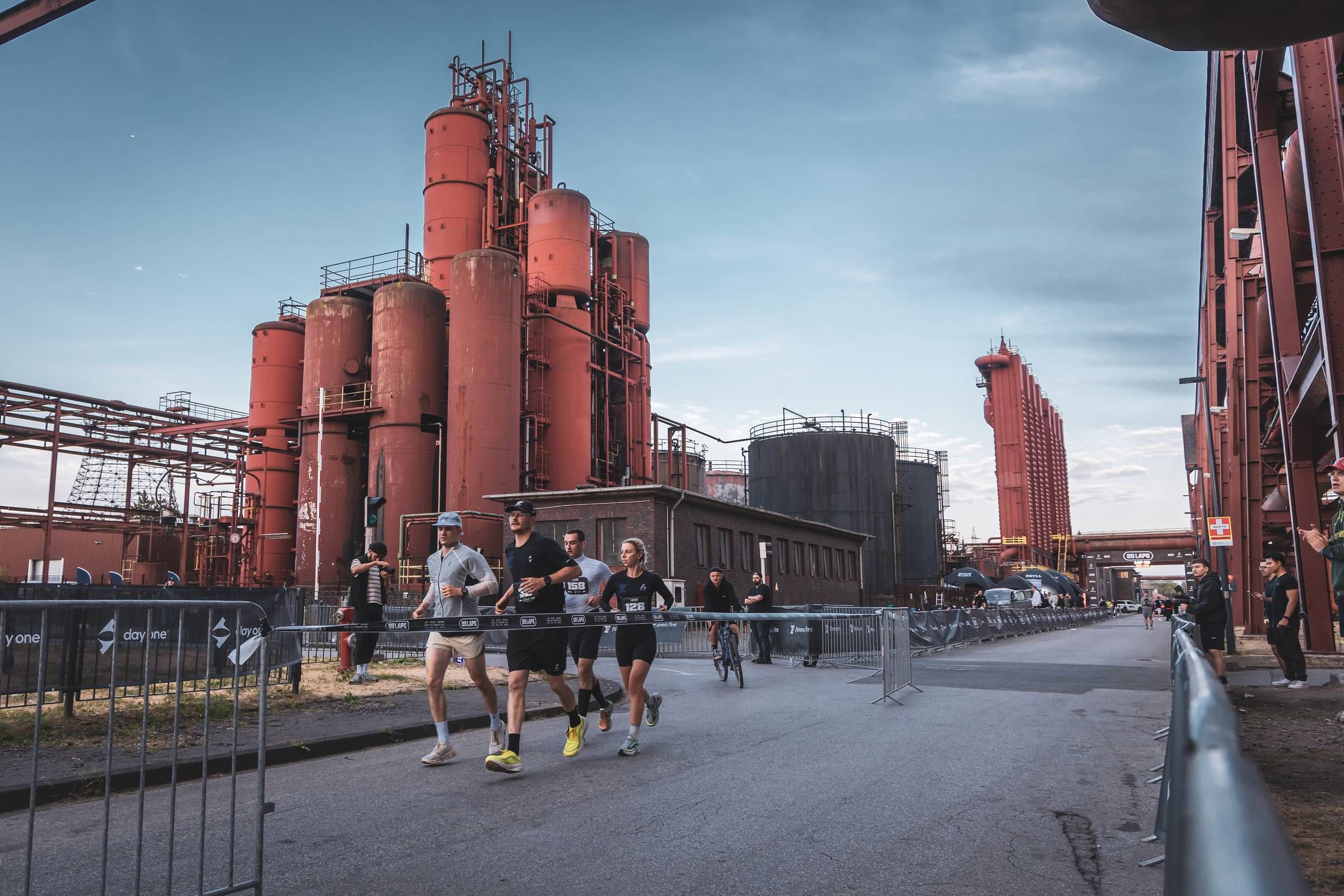 Runners passing the red silos along the course